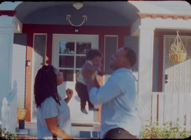 A father throws his baby up in the air
