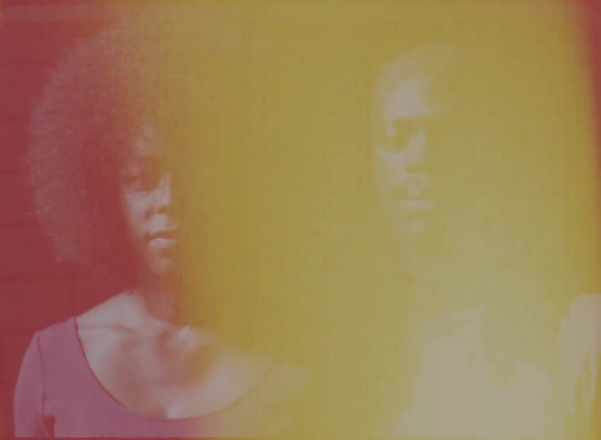 A black man and woman are standing together