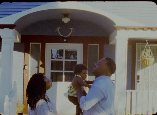 Happy family playing with a toddler in the front door at home in the morning