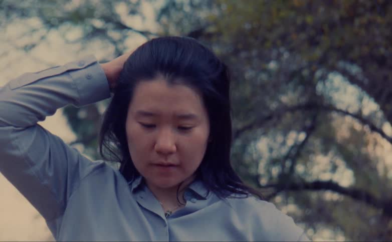 An asian woman dances outside