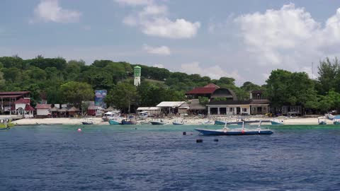 Small boats line the shore of this island