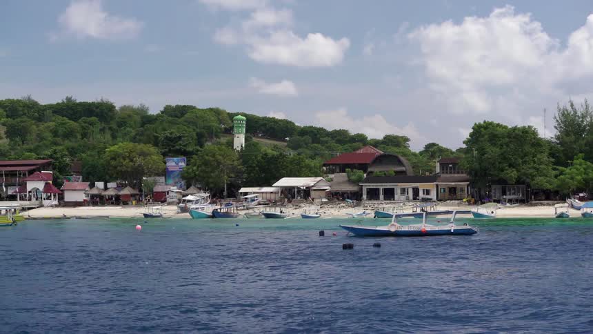 Small boats line the shore of this island