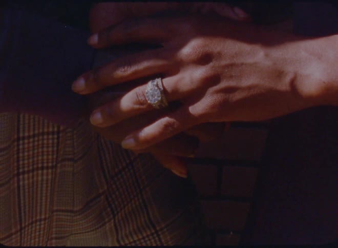 A womans hand with a diamond wedding ring