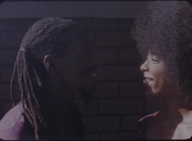 A man and woman talk outside