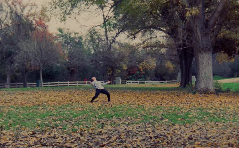 A woman is dancing in the park