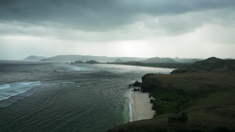 Waves roll onto a beach on a cloudy day