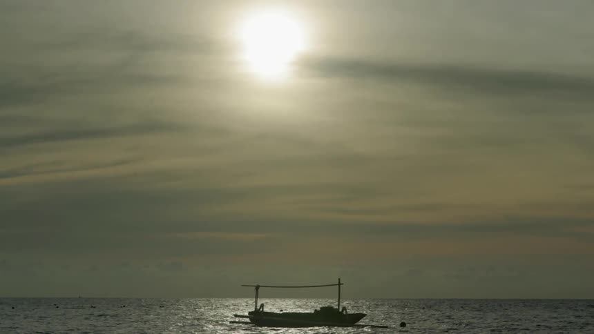 A boat floats on a body of water during the day