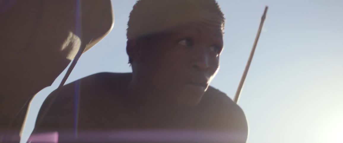 Tribal men go hunting in african field