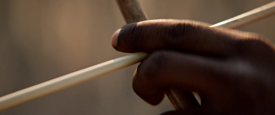Tribal man with a bow and arrow in the savannah