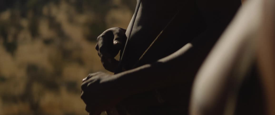 Indigenous hunters carrying bows talking and looking at the horizon