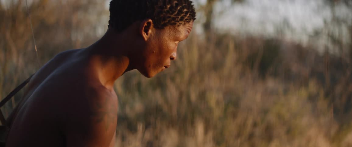 Tribal men with bow tracks down prey to hunt