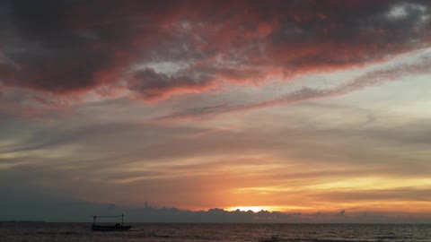 The sun is setting in the distance over the water