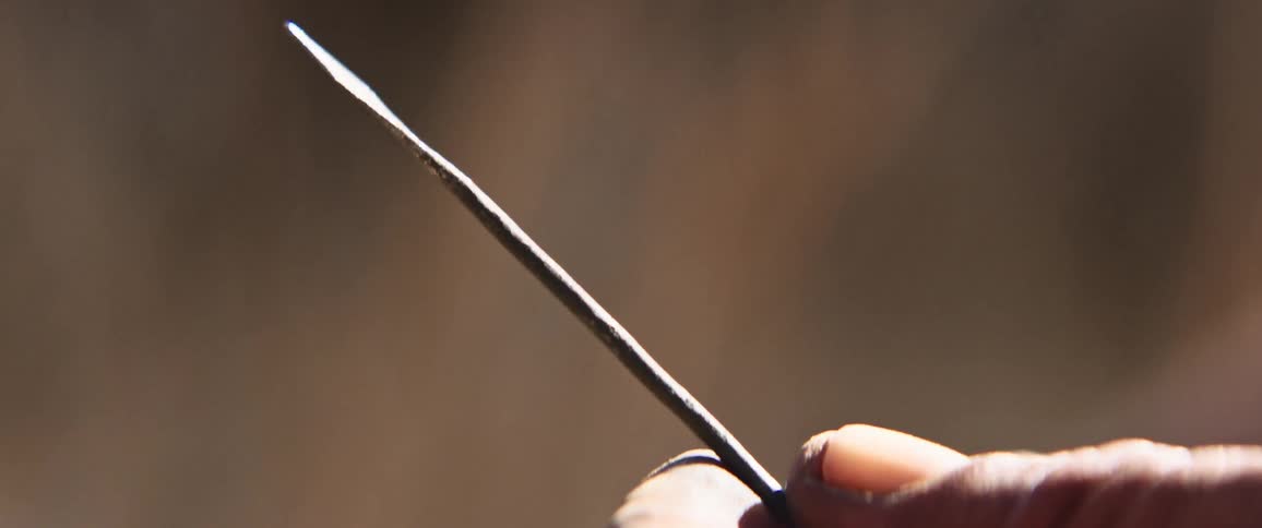 Indigenous african hunter holding an arrow between his fingers