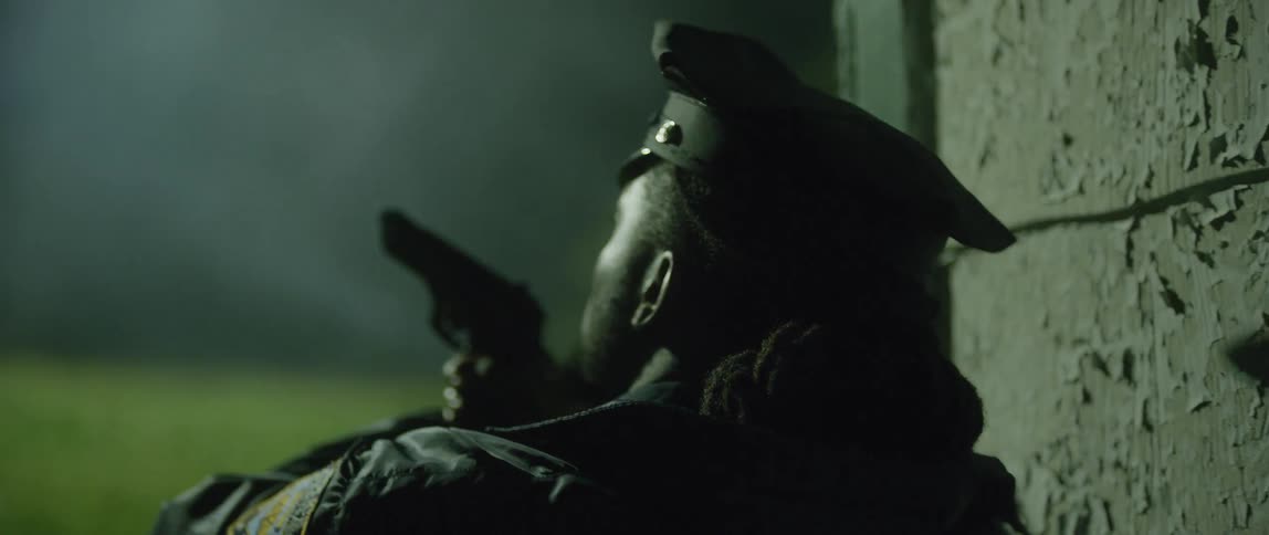 A cop with a gun looks around at the sky