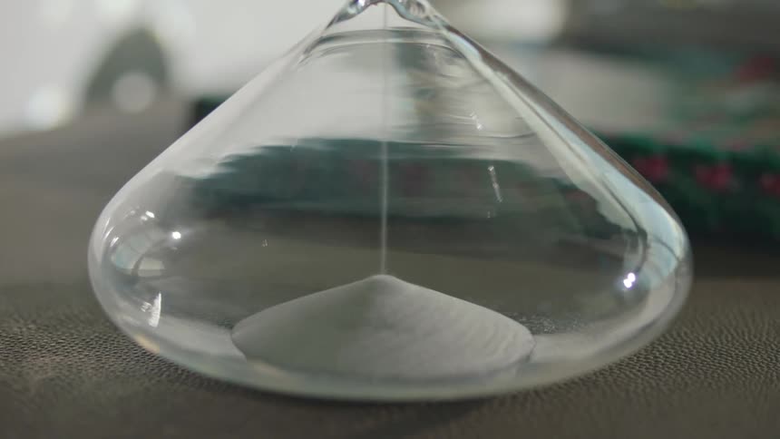 Sand falling through an hourglass