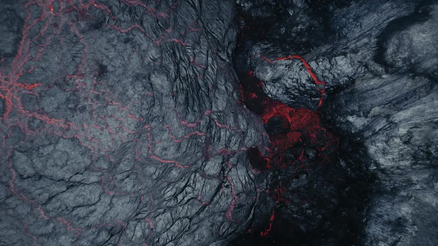 Magma breaks through crust of ash to flow