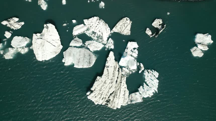 Aerial view of icebergs and broken ice in the arctic water
