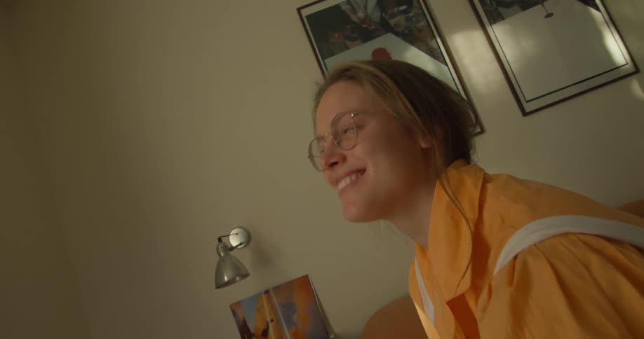 Woman sits smiling and talking with friend