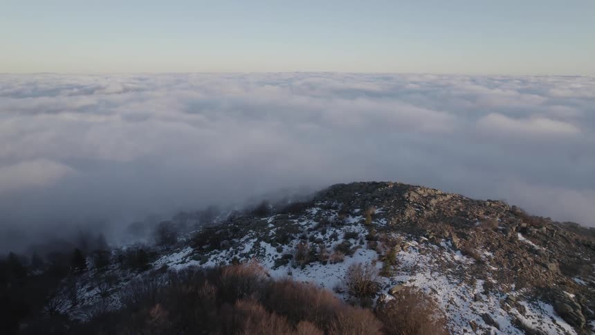 Aerial view of a a valley and clouds is displayed