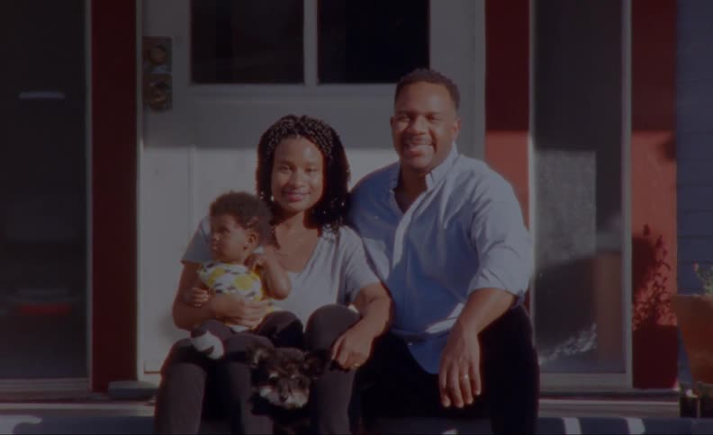 Family sits on front porch with family dog