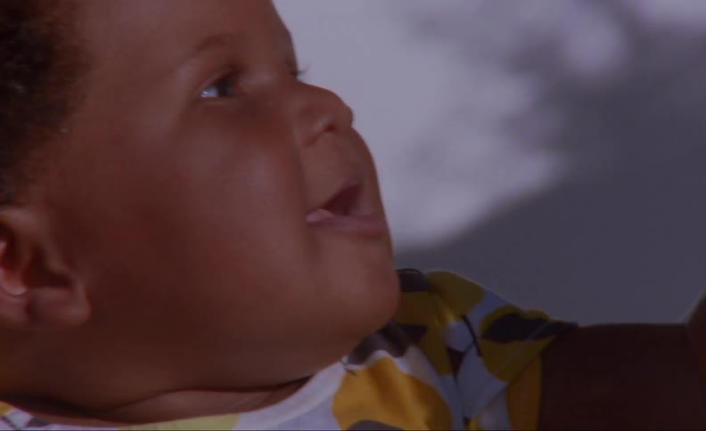 Toddler laughs and reach out