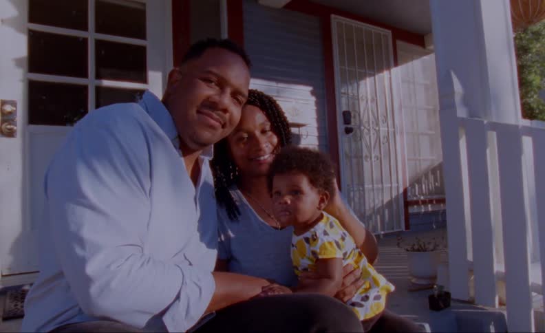 Family sits on front porch steps posing
