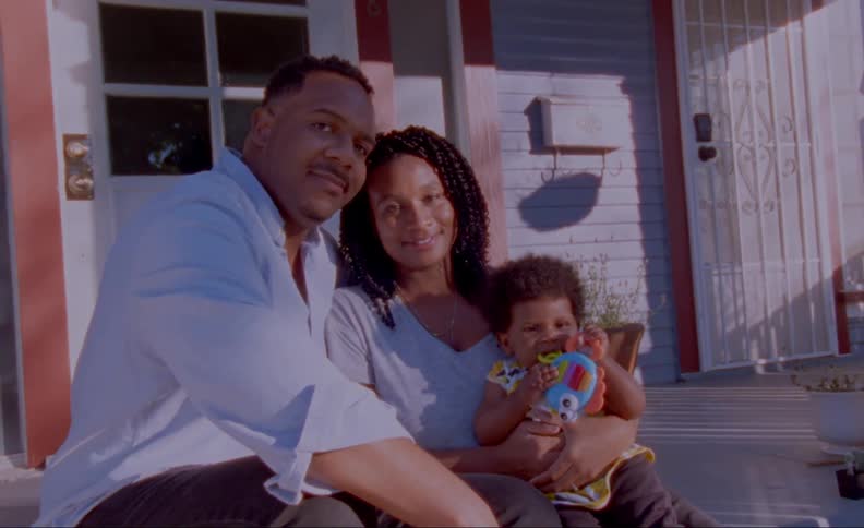 A family is sitting on a patio outdoors