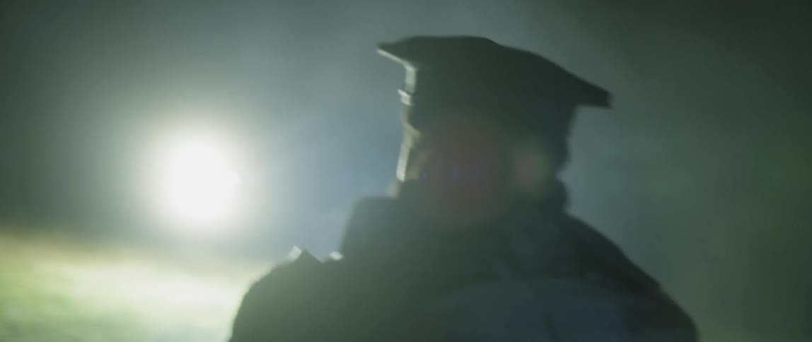 An officer turns around fast with a gun drawn