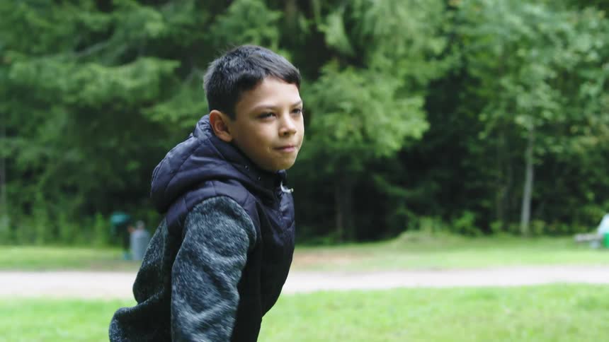 A boy is aiming his frisbee before he throws it and cheers