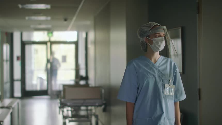 A nurses break is interrupted as another hospital employee calls her from outside