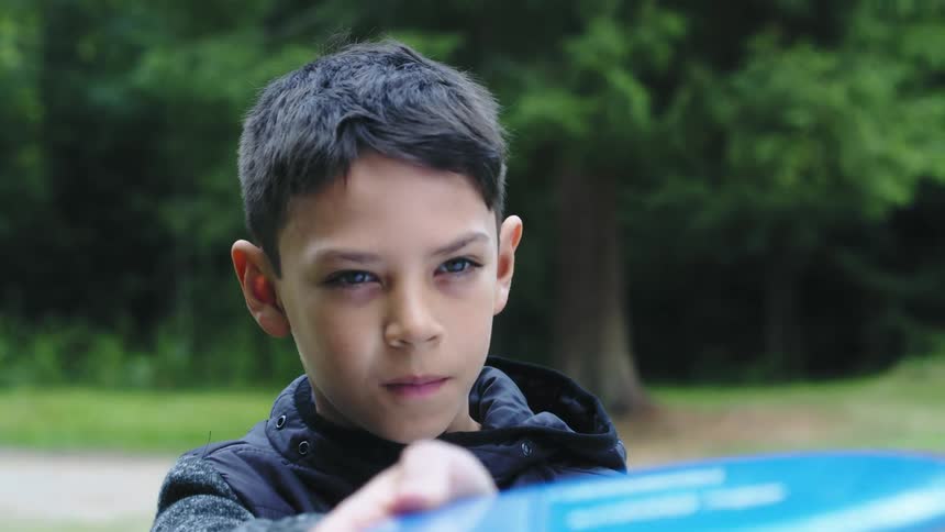 A boy is playing outdoors in spring