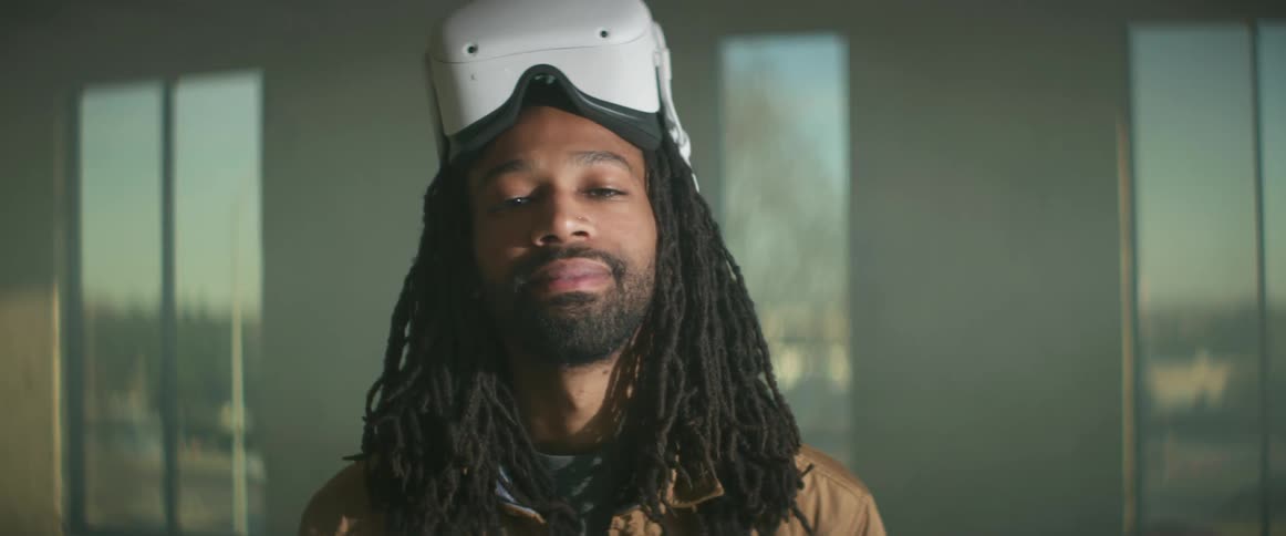 A man stands in the room wearing a virtual reality headset