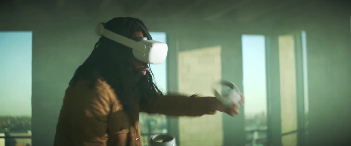 A man punching the air while wearing a virtual reality head set