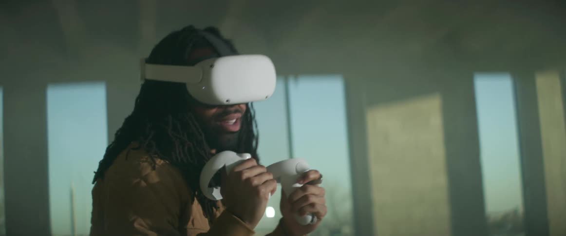 A man with a virtual reality headset on throws punches as he plays