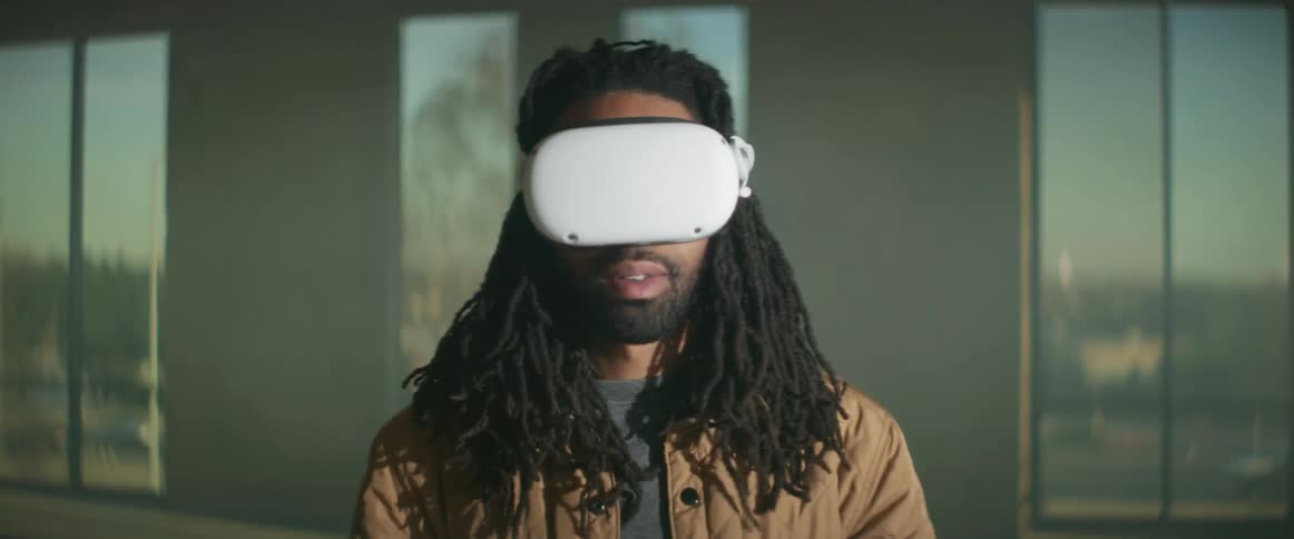 A man is wearing virtual reality goggles