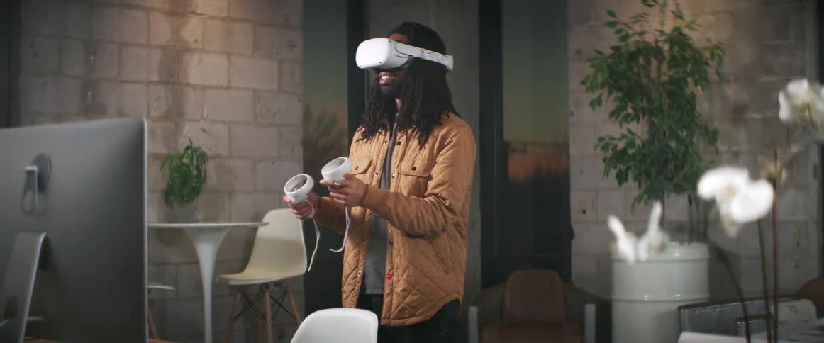 A man is playing virtual reality games in his office