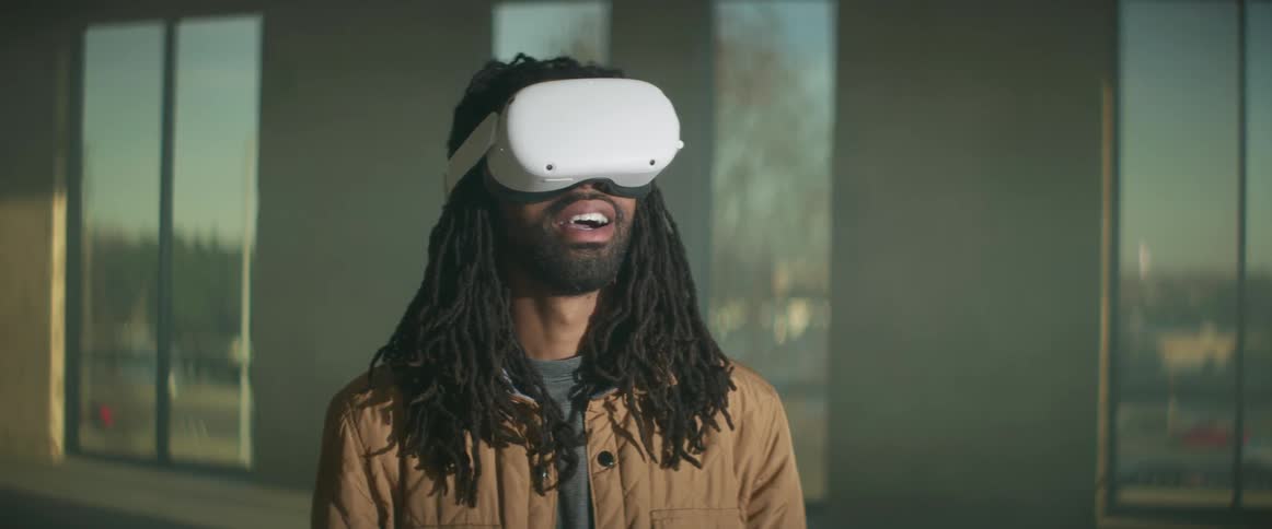 A man is in a building and wearing virtual reality technology
