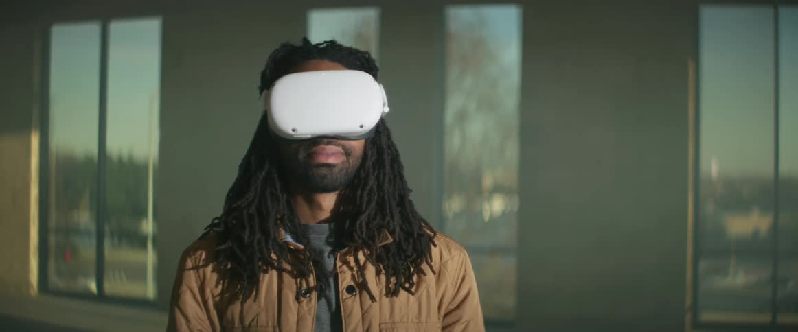 A man putting on a virtual reality headset outdoors