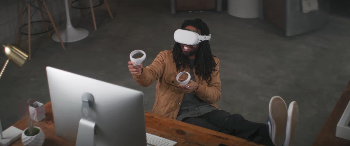 A man playing a virtual reality game at a desk