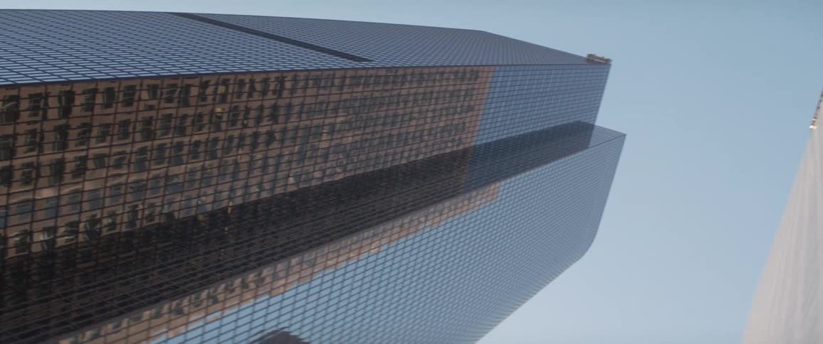 Glass facade of tall skyscrapers in the city skyline against a blue sky at morning