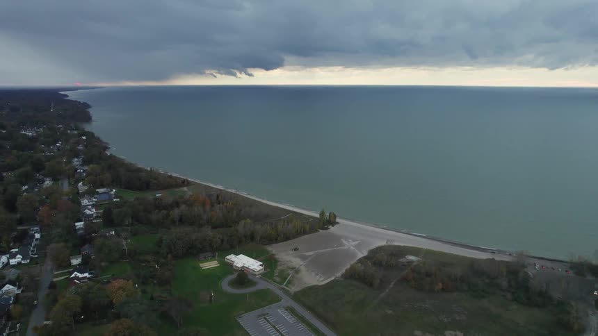 Aerial view of a beach on a small town close to the ocean at sunset