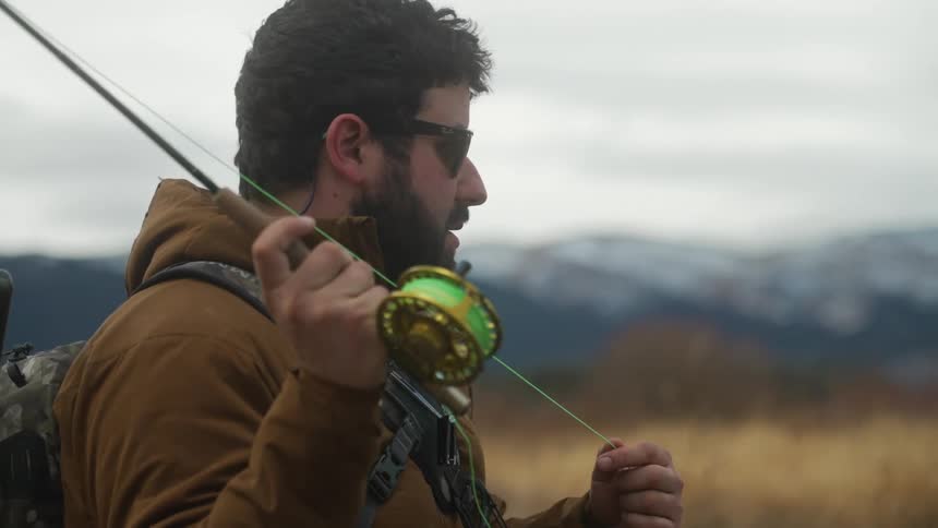 A man is fishing outdoors in autumn season