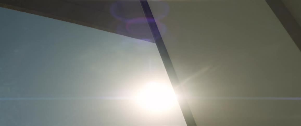 Sun glares from sky into building