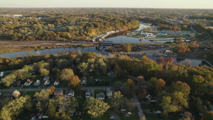 Aerial view of small town next to river with bridge