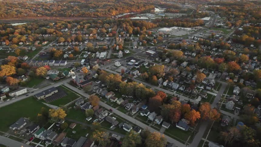 Aerial view of town streets with houses and autumn trees