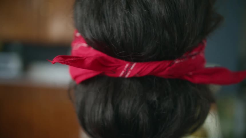 A person is putting a headband in their hair