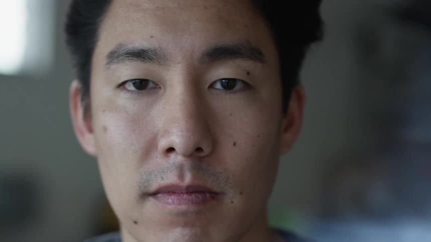 An indoor portrait of an asian man