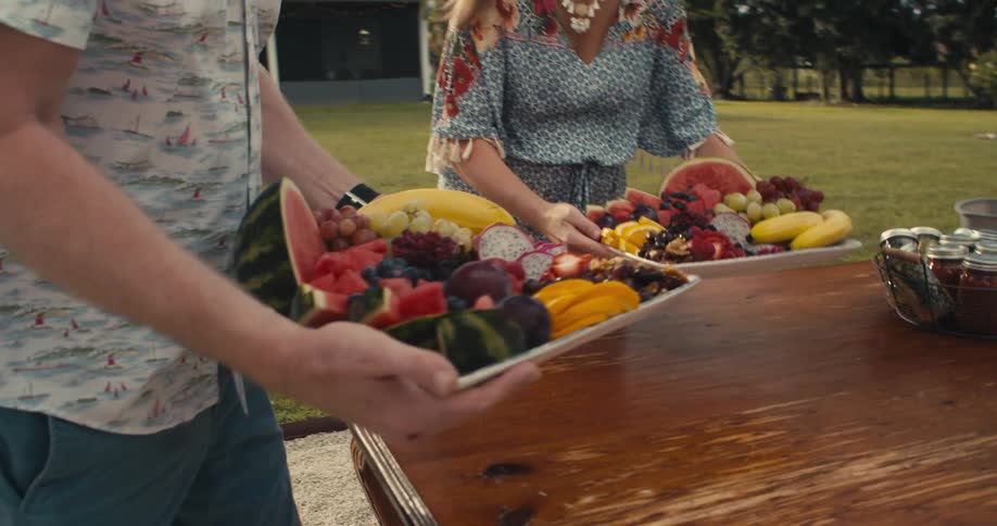 People put trays of food on a table out doors