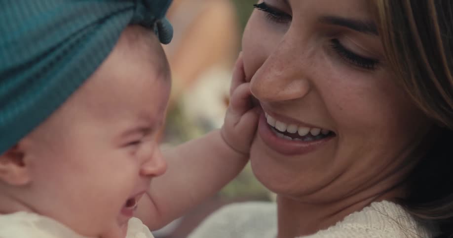 A woman tries to calm down her infant daughter