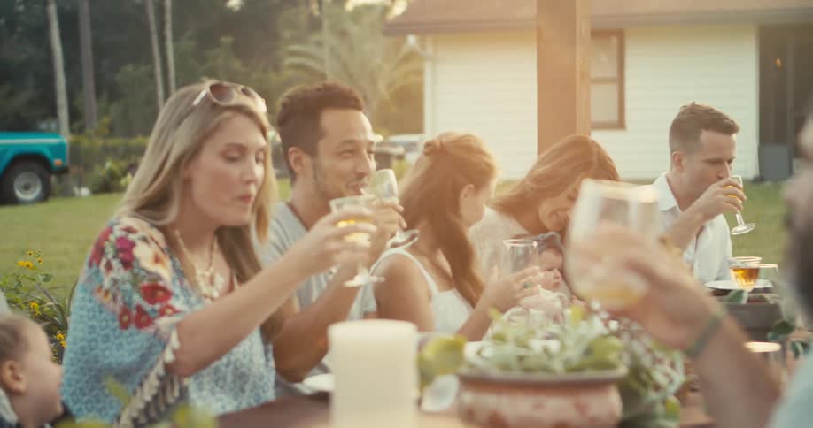 People sit outside having drinks and a meal together